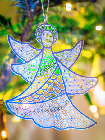 Christmas angel hanging on christmas treeの写真素材