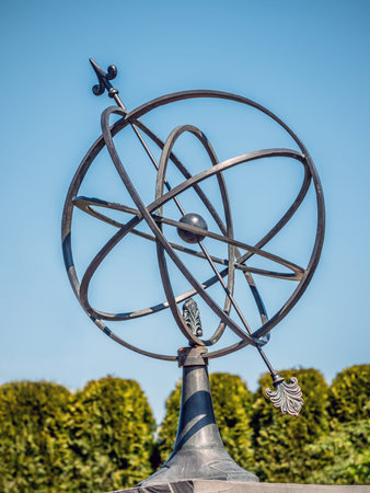 Old metal solar Clock in the garden shot over blue sky