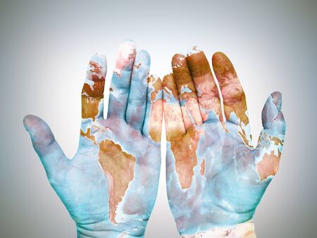 Two male palms with superimposed world map as global awareness and care conceptの写真素材