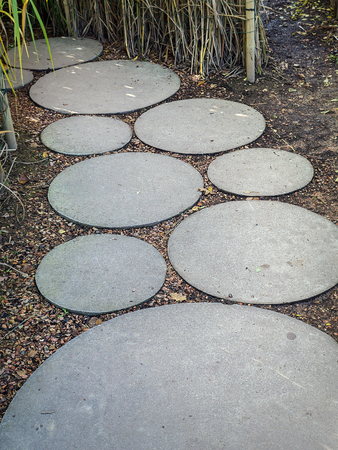 Circle concrete slab path in the gardenの写真素材