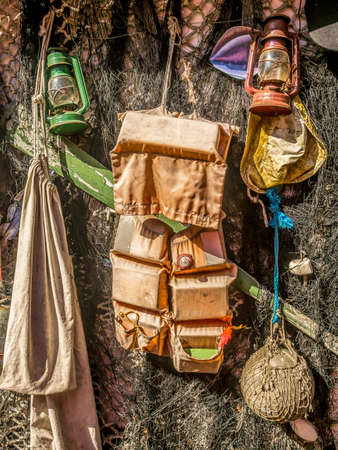 Old fisherman's fit-out and fishing nets drying in the Sunの写真素材