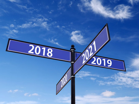 Four-way metal roadsign with past and future Year numbers over blue skyの写真素材