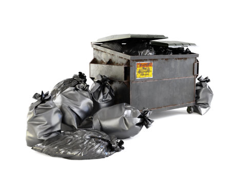 3D rendering of large metal bin full of trash bags on white backgroundの写真素材