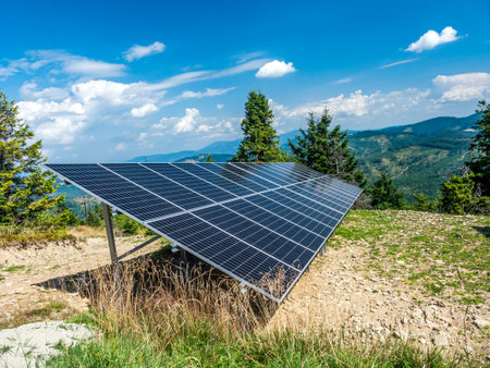Solar panel station mounted on a mountain slope, with beautiful panorama of Beskid Zywiecki mountains in the background, Polandの写真素材