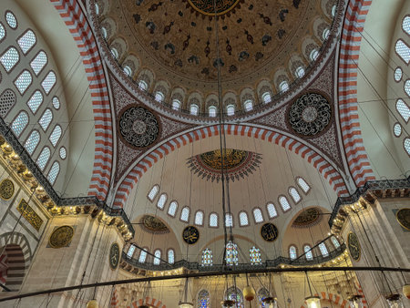 Istanbul, Turkey, Feb 16 2025: Intricately detailed Suleymaniye Mosque interior showcasing stunning architectural elements, stained glass windows, and ornate dome frescoes,Istanbul, Turkeyの写真素材