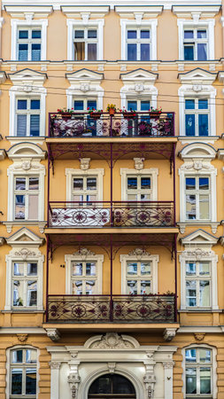 Historic row of colorful European buildings showcasing ornate architectural details including wrought iron balconies and decorative facades, in a picturesque cityscape, Wroclaw, Polandの写真素材