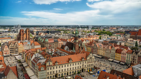 A panoramic overhead view showcasing the historic downtown area, filled with vibrant buildings, churches, and architectural landmarks under a clear blue sky, Wroclaw, Polandの写真素材