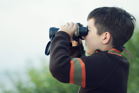 Boy looking through binocular