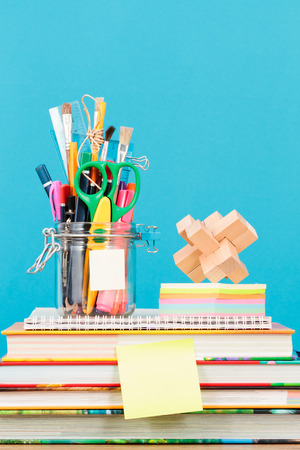 School accessories on desktop with blank blue backgroundの写真素材