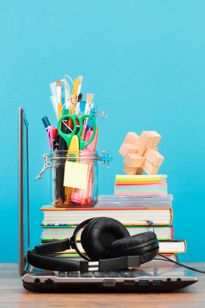 School accessories on desktop with blank blue backgroundの写真素材