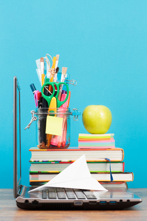 School accessories on desktop with blank blue backgroundの写真素材
