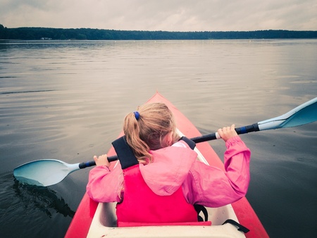 Little girl in kayak on a lakeの素材