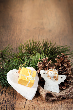 Christmas gift in small box, decorated with earthen heart, pine cones and twigs. Space for textの写真素材