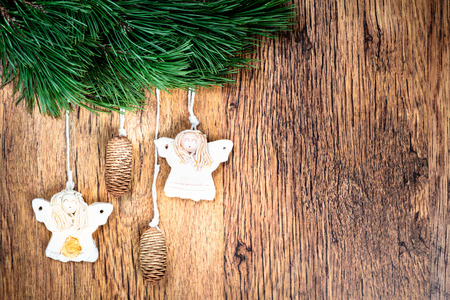 Christmas decoration - pine twigs, earthen crafts on wooden background. Space for textの写真素材
