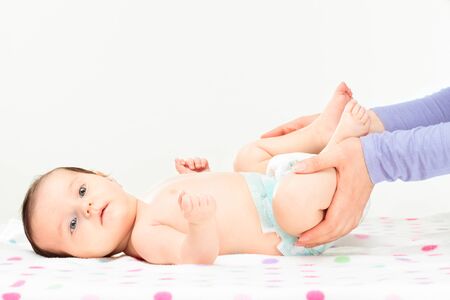Mom holding her little daughter's feet. Copy space aboveの写真素材