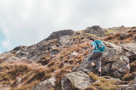 Teenager hiking alone in the mountainsの写真素材