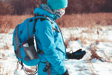 Boy using the mobile phone during the winter tripの写真素材