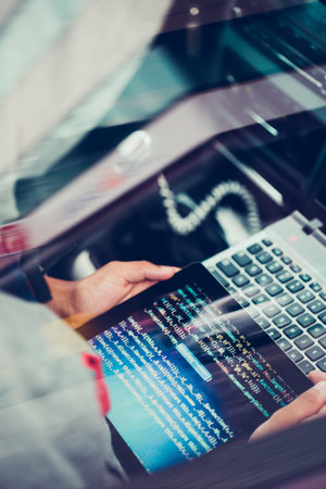 Hacker using computer, smartphone and coding to steal password and private data remotely from car....