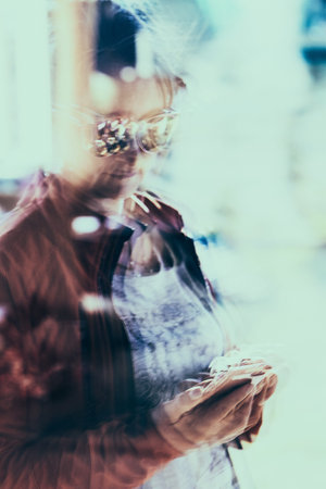 Reflection in a window glass of woman which is using mobile phone. Real people, authentic situations