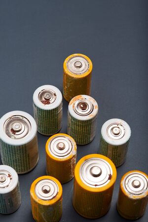 Discharged batteries on paper background. Collecting used batteries to recycle. Waste disposal and recycling. Copy space for textの写真素材