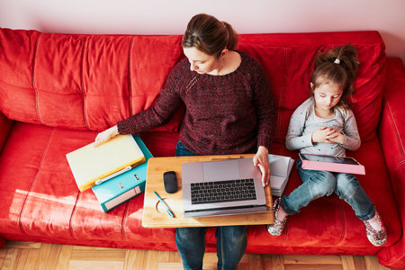 Woman mother working doing her job remotely during video chat call stream online course webinar on...