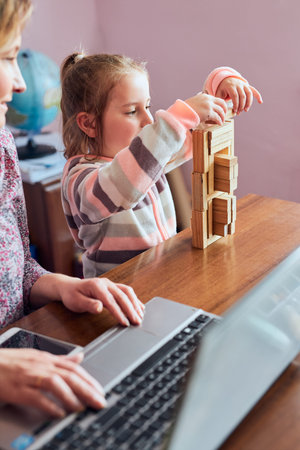 Woman mother working doing her job remotely during video chat call stream online course webinar on...