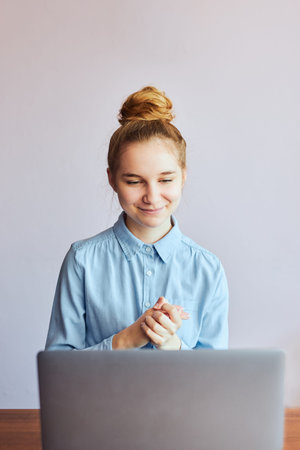 Young woman student having classes, learning online, watching lesson remotely, listening to...