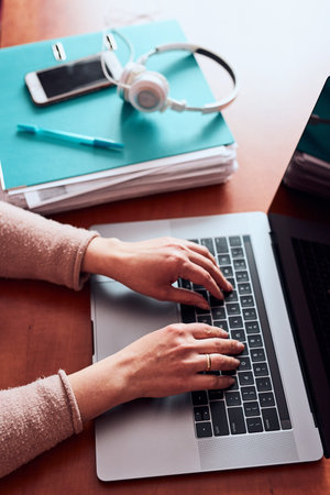 Woman working talking doing her job remotely during video chat phone call on laptop from home. Woman...
