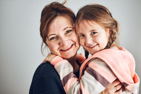Happy mother and daughter embracing, hugging and smiling together. Family portrait. Happy moment....