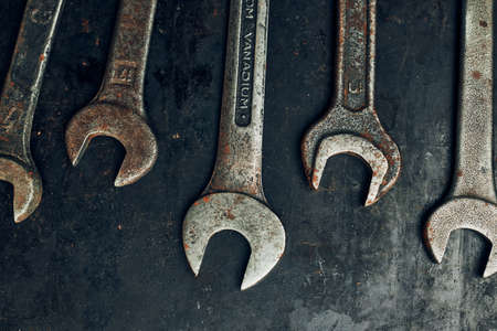 Spanners on steel surface. Old rusty wrenches for maintenance. Mechanic hardware tools to fix. Technical tools background with copy spaceの写真素材