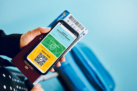 Digital covid certificate. Covid vaccination digital pass. Woman passenger holding digital medical...