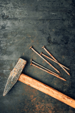 Hammer and nails on steel surface. Tools for maintenance. Hardware tools to fix. Technical...