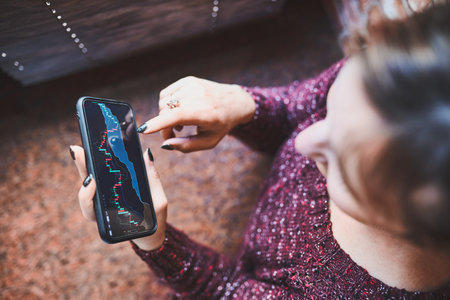 Person investing trading on stock cryptocurrency market using investing application on smartphone....