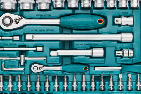 Ratchet with many attachments in plastic case. Work tools. Universal tool set. Background