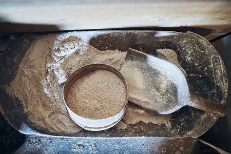 Sifting flour. Bolting flour. Flour in wooden bowl. Old rustick kitchen utensils
