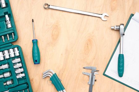 Workshop table with many tools. Wrench, spanner, calliper and ratchet with many attachments. Work...
