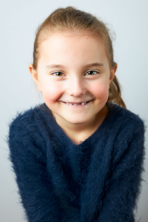 Portrait of adorable little girl. Cute small child looking at camera. Portrait of girl wearing blue...