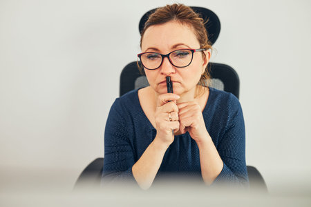 Woman entrepreneur focused on solving difficult work. Confused businesswoman thinking hard looking...