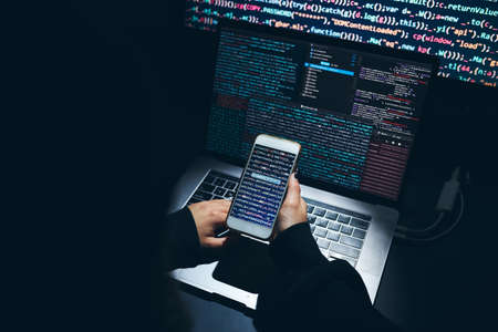Cyber security threat. Young woman using computer and coding. Internet and network security. Stealing private information. Person using technology to steal password and private data. Cyber attack crimeの写真素材