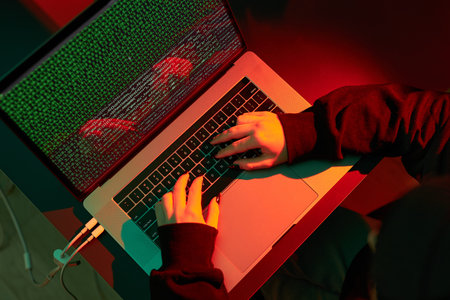 Anonymous people using computer and programming to break code. Cyber security threat. Internet and...