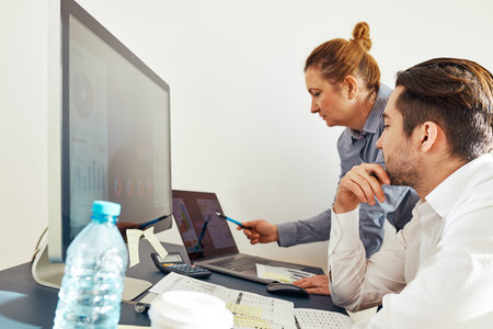 Business colleagues discussing financial data working together in office. People entrepreneurs...