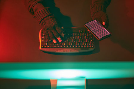 Anonymous people using computer and programming to break code. Cyber security threat. Internet and...