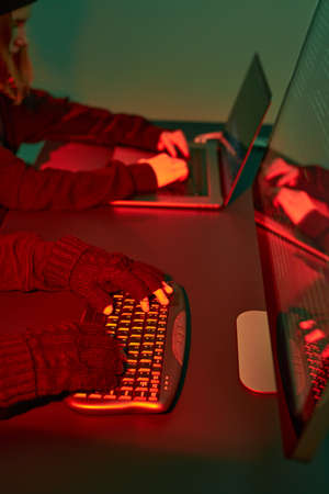 Cyber attack. Hackers breaking security. Anonymous people access secret data. Cyber war. Anonymous people using computer and programming to break code. Access to private data. Cyber security threatの写真素材