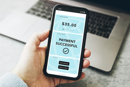 Man paying with smartphone for online shopping. Paying using fast secure payment system. Paying bills using express payment technology. Paying expenses online. Ordering product online using smartphone. Confirmation payment successful displayed in store app on smartphone screen. Express paymentの写真素材