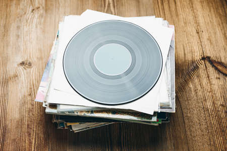 Stack of vinyl records. Listening to music from record. Playing music from analog disk. Retro and vintage. Audio stereo. Analog soundの写真素材