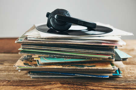 Stack of vinyl records. Listening to music from record. Playing music from analog disk. Retro and vintage. Audio stereo. Analog soundの写真素材