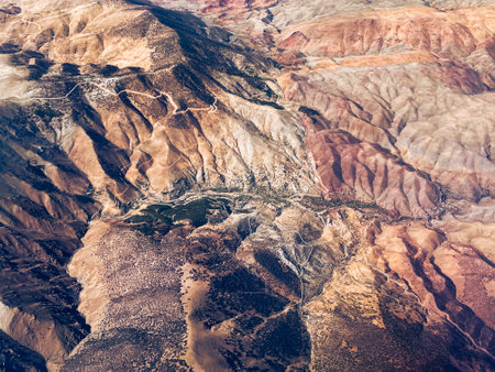 Aerial view of high desert mountains. Mountain landscape. Beauty in nature. Inaccessible mountain peaks. Looking at the Earth from an airplane window. Aerial view of the land.の写真素材