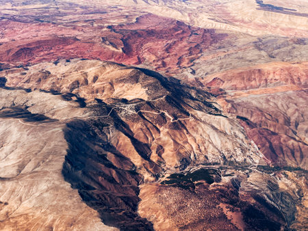Aerial view of high desert mountains. Mountain landscape. Beauty in nature. Inaccessible mountain peaks. Harsh climate. Looking at the Earth from an airplane window. Aerial view of the land. Africa landの写真素材