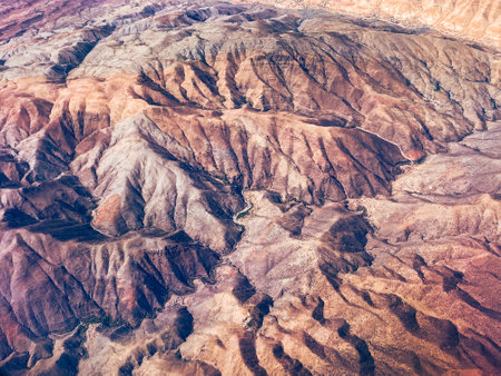 Aerial view of high desert mountains. Mountain landscape. Beauty in nature. Inaccessible mountain peaks. Looking at the Earth from an airplane window. Aerial view of the land.の写真素材