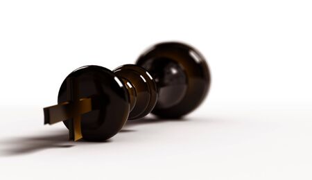 The black chess king which lies on a surface of white colourの写真素材